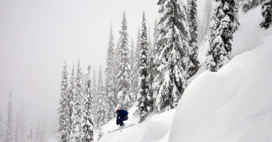 Skiier hitting a jump at Red Mountain Resort BC - Rams Head Inn